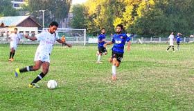 Players in action during a football match at Polo Ground in Srinagar on Friday.