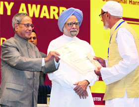 President Pranab Mukherjee presents a citation to Mohammad Abdul Bari from Odisha at the National Communal Harmony Awards function in New Delhi on Friday.