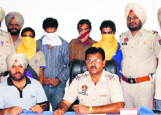 Four of the accused in a drug peddling case in police custody in Amritsar on Saturday. 