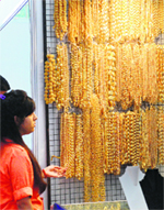 Gold jewellery on display at a gem fair in New Delhi on Saturday.  AFP