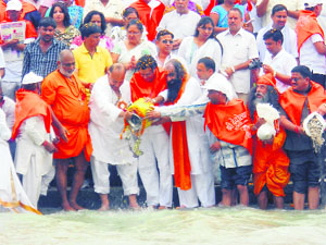 Ashes of unidentified people being immersed in the Ganga by Shri Devothan Samiti members at Kankhal in Haridwar on Saturday. 