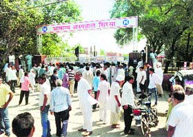 Angry relatives of a woman hold a demonstration after locking the main gate of General Hospital at Sirsa on Saturday