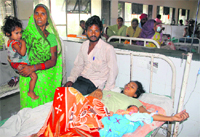 Dhanraj with his wife Pinky at the Civil Hospital in Jalandhar on Saturday. Photo: Sarabjit Singh