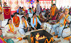 Principal Alok Betab and the staff members participate in a havan on the occasion of 115th birth anniversary of Maharaja Hari Singh in Jammu on Saturday