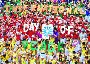 Schoolchildren give a colourful presentation on the International Day of Peace in Patiala on Saturday.