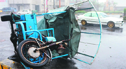 A three-wheeled vehicle lies on its side after being blown over by Typhoon Usagi in Hengtsun town, Taiwan, on Saturday. AFP