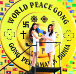 Miss World 2012 WenXia Yu of China (L) and Miss Indonesia Vania Larissa sound the World Peace Gong in Bali, Indonesia, on Sept 21, the International Day of Peace. The Miss World final will be held on Sept 28. AFP