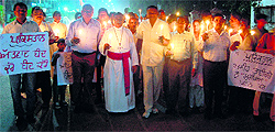 Members of the Church of North India hold a candlelight march to pay respect to the victims of a bomb blast at a church in Peshawar, Pakistan, at St Paul's Church in Amritsar on Sunday