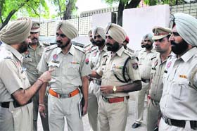 Police officials discuss a point before conducting a checking at the bus stand