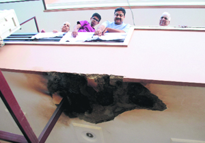 Residents show a portion of the house that was damaged in blasts triggered by a live wire in Sector 12-A, Panchkula, on Sunday.