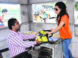 Sneha, a relative of Pankhuri (who forgot her bag in an auto), takes back the bag from a pre-paid booth in Sector 22 on Sunday.