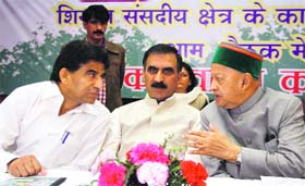 Chief Minister Virbhadra Singh talks to All-India Congress Committee secretary and MP Raja Ram Pal (left) as state Congress president Sukhvinder Singh Sukhu (centre) looks on, at the Congress office in Shimla on Sunday