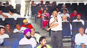 Bidders at the auction of plots and booths in Jalandhar on Sunday. 