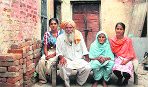 Sisters Rekha and Raman with their grandparents, vision-impaired Gurdev Singh and Kartar Kaur, at their ramshackle house at Chuharwali village in Jalandhar on Sunday. 