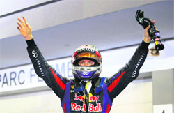 Red Bull Formula One driver Sebastian Vettel celebrates after winning the Singapore Grand Prix at the Marina Bay street circuit in Singapore on Sunday. 