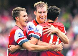 Arsenals Per Mertesacker (centre) is congratulated by teammates after scoring a goal against Stoke City during their Premier League match on Sunday. 