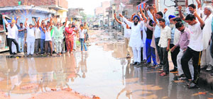 Residents of Mohkampura, which falls in Ward 18, protest against the lack of civic amenities in their area in Amritsar. 