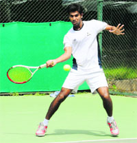 A player returns a shot during the tennis tournament at the CLTA courts in Chandigarh on Monday. 