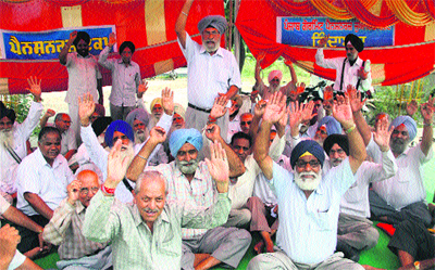 Members of Punjab Government Pensioners Joint Forum hold protest in Jalandhar on Monday