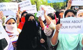  Students hold placards during a protest in Srinagar on Monday.