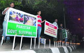 Members of the Nation Forum for Peoples Rights during a candlelight march to protest against the suicide bombers attack on the historic church in Northern Pakistan, in Ludhiana on Sunday.