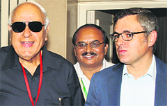 Union Minister Farooq Abdullah with his son and J&K CM Omar Abdullah in New Delhi. Tribune photo