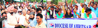 Christians hold a rally at the Attari-Wagah joint check post, near Amritsar, on Tuesday against the terrorist attack on a church at Peshawar in Pakistan. 