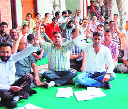 Members of the Punjab Health Department Subordinate Clerical Association protest outside the Civil Surgeons office during their strike in Amritsar on Tuesday. 