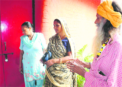 Om Parkash, Geeta devi and Roshni, residents of Colony No 5, who came to enrol themselves to open a bank account, looks at the locked door at the Bal Bhavan in Sector 23, Chandigarh, on Tuesday. Tribune photo: Parvesh Chauhan 