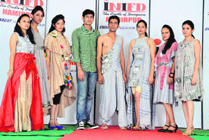Students display dresses during a fashion show at the International Institute of Fashion Design (INIFD) in Hamirpur.