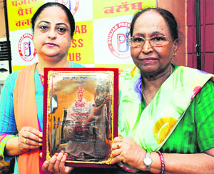 Hindi writer Dr Kirti Kesar shows her award received from Uttar Pradesh Hindi Sansthan in Jalandhar on Tuesday.