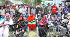 The Rashtriya Rifles (RR) distributes aid to residents of Dhadkai village in Batote on Tuesday.