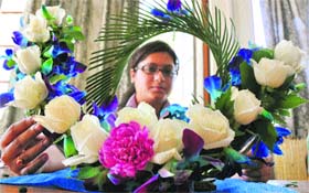 A participant displays her talent during the flower arrangement competition at the Jammu University on Tuesday.