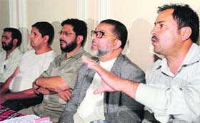 All Kashmir Wholesale Mutton Dealers' Union president Mehraj-ud-Din Ganaie along with senior dealers addresses a press conference in Srinagar on Tuesday.