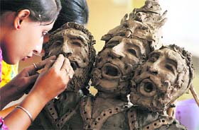 A girl takes part in a clay modelling competition at the Khalsa College for Women in Ludhiana.