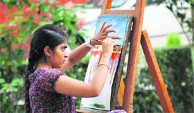 A girl makes a painting during on-the-spot painting competition held at Khalsa College for Women in Ludhiana on Tuesday.
