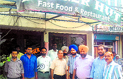 A team of the Municipal Corporation disconnects the water and sewerage connections of tax defaulter Burger Hut, located opposite Khalsa College, in Amritsar on Wednesday