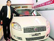Nagesh Basavanhalli, managing director, Fiat Chrysler India, poses with Linea Classic at its launch in New Delhi on Wednesday. The car is priced between `5.99 lakh and `7.50 lakh (ex-showroom, Delhi)