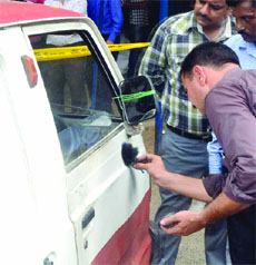 Police gather clues from the van found abandoned at Karol Bagh in New Delhi on Wednesday.