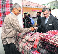 Chief Minister Omar Abdullah visits a stall at the inaugural day of Dast-e-Hunar, the National Handloom Expo 2013, at Kashmir Haat in Srinagar on Wednesday.