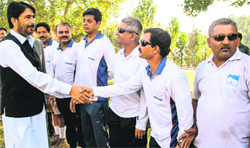 Minister of State for Tourism Ghulam Ahmad Mir interacts with cyclists participating in the Kashmir to Kanyakumari race in Awantipora in south Srinagar on Wednesday. Photo: Yawar Kabli 
