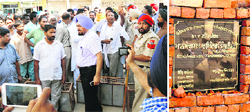 Officials pacify agitated SAD and BJP workers in Ferozepur on Wednesday; and (right) the damaged foundation stone of a sewerage project. Tribune photos