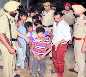 Child labourers being taken out from an embroidery unit by the Punjab Police during a raid conducted on the unit following court orders, in Jalandhar on Thursday night