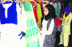 A woman looks at a collection of Pakistani suits in Srinagar. A Tribune photograph