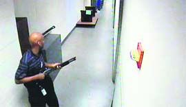 Aaron Alexis moves through a building carrying a shotgun in this photo released by the FBI on Thursday.