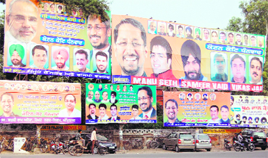 Leaders and supporters of the BJP put up hoardings at Crystal Chowk to welcome new Local Bodies Minister Anil Joshi to Amritsar on Friday. Photo: Sameer Sehgal