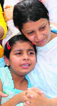His wife and daughter break down during his funeral in Chandigarh on Friday