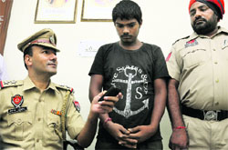 The accused in police custody at Phase VII in Mohali on Friday. 