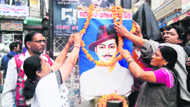 People garland the portrait of Shaheed Bhagat Singh on his 106th birth anniversary celebrations in Mussoorie on Friday.