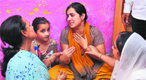 The widow of constable Shiv Kumar being consoled by her relatives as her daughter looks on at their residence in Kathua district.